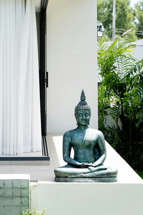 Tranquil Buddha statue with tropical greenery adding a serene touch