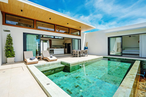 Poolside villa exterior with open-plan living, lounge and alfresco dining by the pool