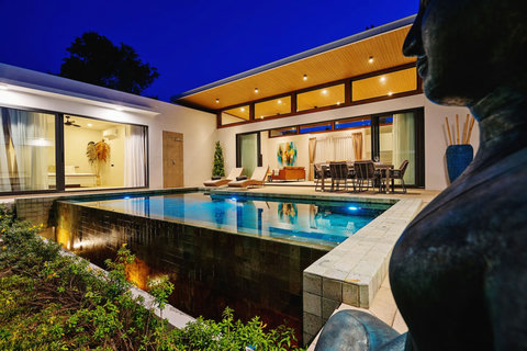 Breathtaking evening villa architecture - Modern luxury illuminated at dusk with pool reflections