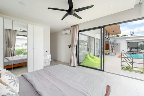 This bedroom is flooded with light and opens straight onto the garden — peace and freshness