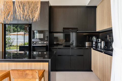 Fully equipped modern kitchen with sleek dark cabinetry in Elysium Villa, Koh Samui