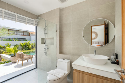 Elegant ensuite bathroom with freestanding bathtub and pool view, Elysium Koh Samui
