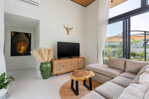 Bright living room with floor-to-ceiling glass doors opening to the garden, Elysium Villa