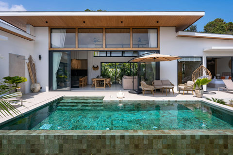 Relaxing poolside sun loungers with parasol at luxury Bophut vacation rental