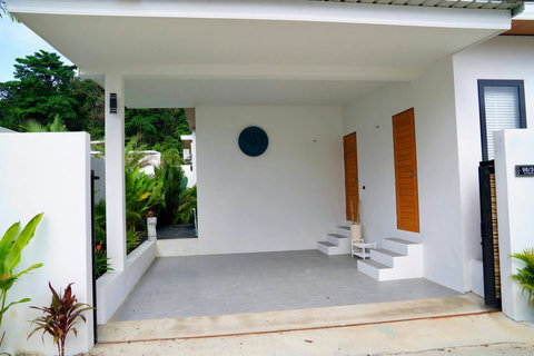 Covered parking and entrance at modern Koh Samui vacation villa in Bophut