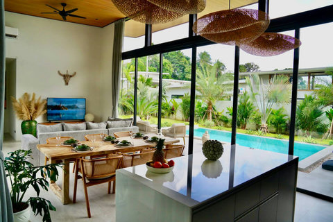 Tropical-style living and dining area with direct pool access in Bophut Samui villa