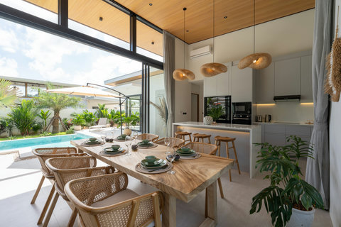 Open-plan dining and kitchen area in Koh Samui villa with pool views and natural light