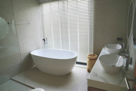 Luxury ensuite bathroom in Bophut villa with freestanding bathtub and rain shower