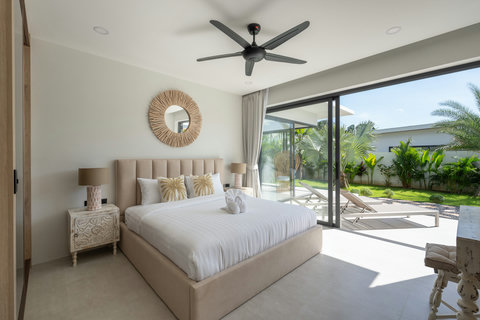 Master bedroom in Bophut villa with king bed ceiling fan and direct garden access