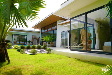 Modern Koh Samui vacation villa exterior with manicured lawns and contemporary design