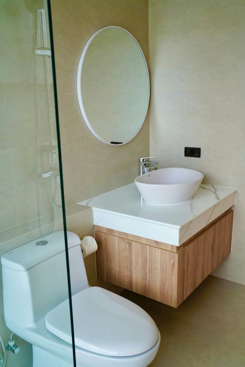 Modern ensuite bathroom in Koh Samui villa with rain shower and designer fixtures