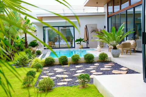 Covered outdoor terrace in Bophut villa with seating area and private pool views