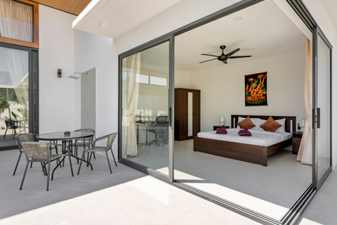 Modern open-plan living room with state-of-the-art entertainment system, comfortable seating, and full pool visibility