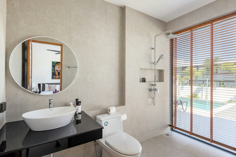 Bright guest bedroom with direct terrace access, quality furnishings, ceiling fan, and seamless indoor-outdoor flow