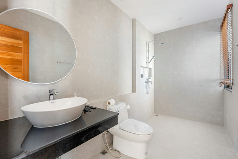 Luxurious spa-inspired en-suite bathroom with freestanding soaking tub, rainfall shower, and premium designer finishes