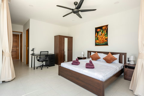 Luxurious primary bedroom with spectacular pool view, high ceiling, elegant furnishings, and private terrace access