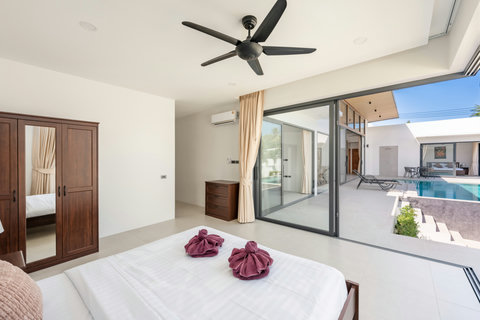 Comfortable guest bedroom with quality furnishings, natural light, and access to villa's exclusive pool and garden facilities