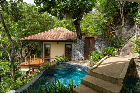Private Thai-style cottage pavilion at Bang Kao villa with natural rock features plunge pool and tropical setting