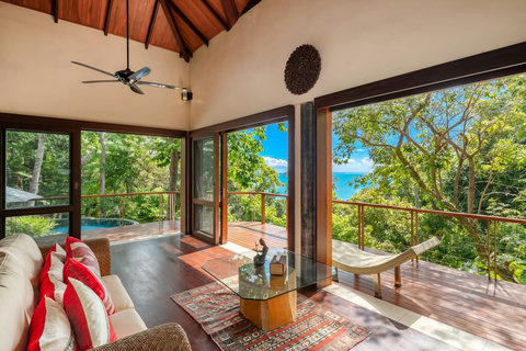 Spacious bedroom in Bang Kao villa with king bed ceiling fan sliding doors and direct tropical garden pool access