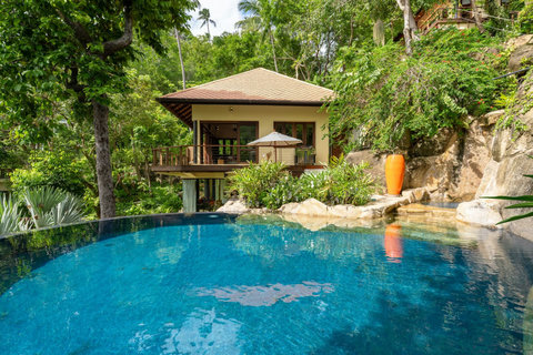 Dramatic natural rock pool feature at Bang Kao luxury villa surrounded by emerald plunge pool and tropical flora