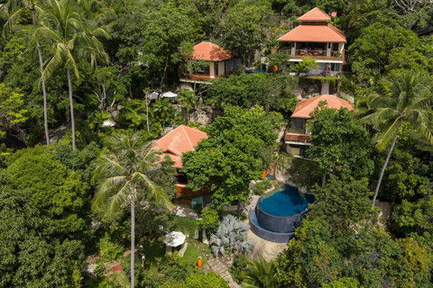Serene master bedroom at Bang Kao villa with king bed tropical ensuite bathroom and garden terrace access