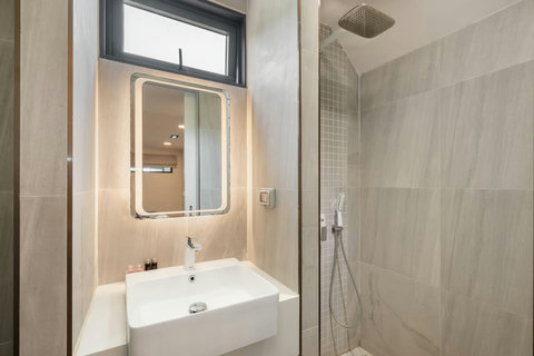 Bright white bathroom with rain shower at Villa J3, Replay Residence Bangrak Koh Samui