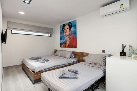 Bedroom with turquoise accents and balcony at Villa J3, Replay Residence Bangrak Koh Samui