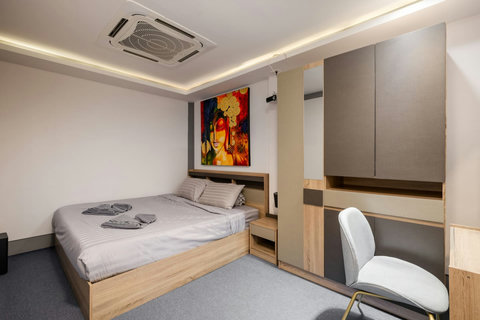 Cozy bedroom with teal accents and hillside views at Villa J3, Replay Residence Bangrak Koh Samui