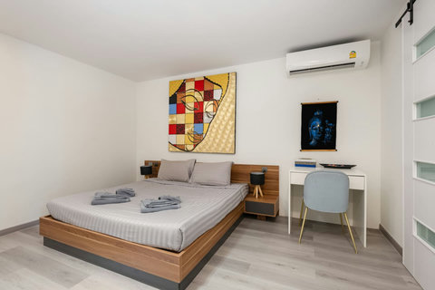 Twin bedroom with colorful artwork at Villa J3, Replay Residence Bangrak Koh Samui