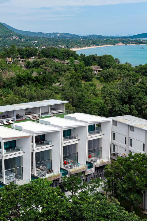 Multi-level villa exterior with tropical landscaping at Villa J3, Replay Residence Bangrak Koh Samui