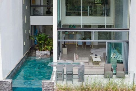 Interior pool view through glass doors at Villa J3, Replay Residence Bangrak Koh Samui