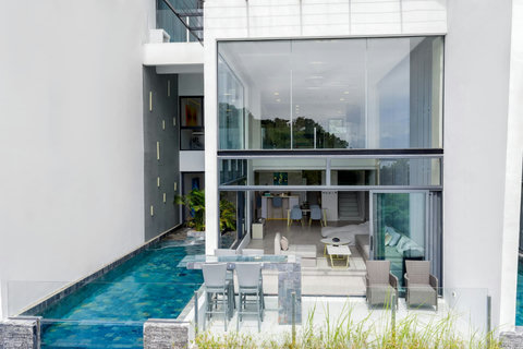 Infinity pool with glass edge and living area at Villa J3, Replay Residence Bangrak Koh Samui