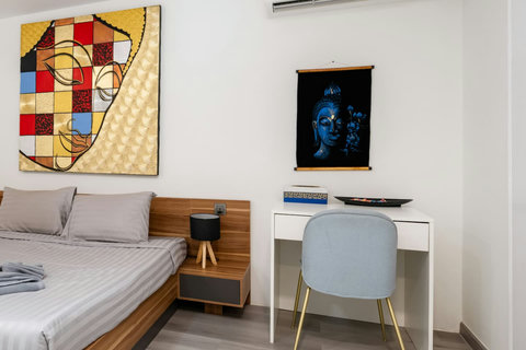 Spacious bedroom with workspace and wardrobe at Villa J3, Replay Residence Bangrak Koh Samui