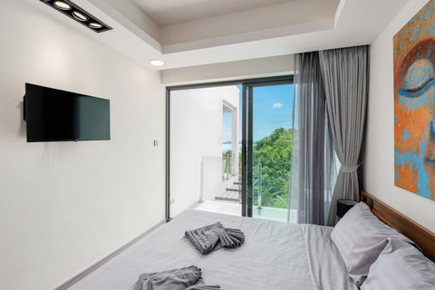 Ocean view bedroom with modern furnishings at Villa J3, Replay Residence Bangrak Koh Samui