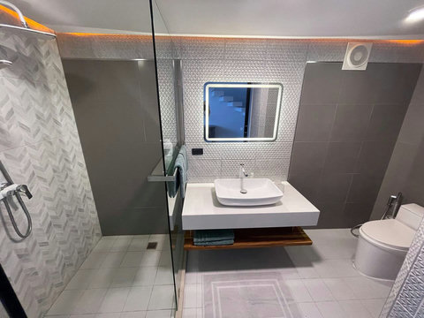Clean white-tiled bathroom with walk-in shower at Villa Q1, Replay Residence Bangrak Koh Samui