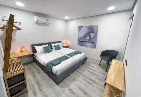 Cozy double bedroom with green accents at Villa Q1, Replay Residence Bangrak