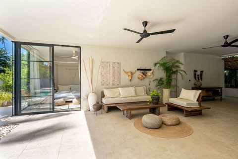 Breezy outdoor living pavilion with ceiling fans