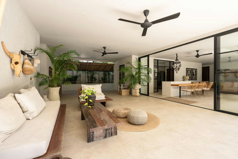 Covered outdoor living area with stylish tropical decor