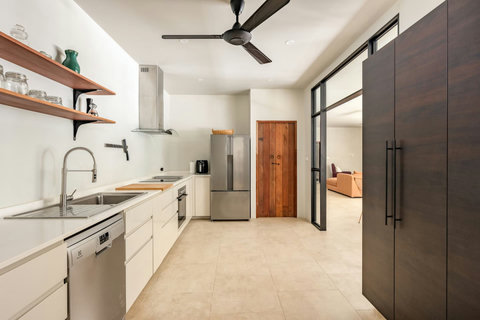 Modern fully-equipped kitchen with white cabinets