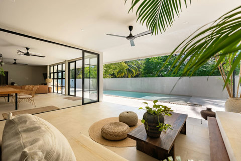 Covered outdoor living area with comfortable seating and sea views