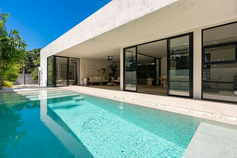 Shaded poolside walkway with lush greenery