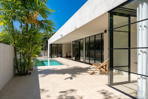 Pool terrace with sun loungers and tropical surroundings