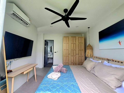 Master bedroom with ceiling fan and elegant dark decor