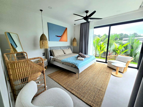 Cozy bedroom with tropical blue theme and ceiling fan