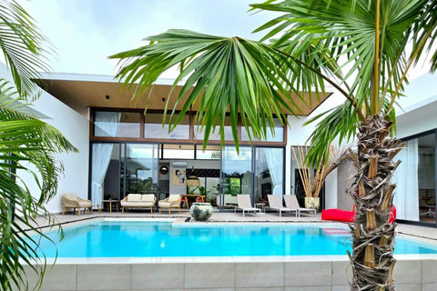 Villa exterior with private pool and tropical landscaping