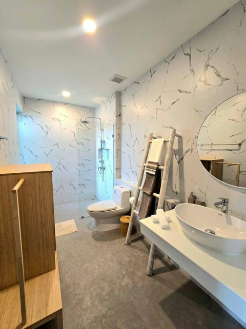 Pristine white bathroom with soaking tub and fresh linens