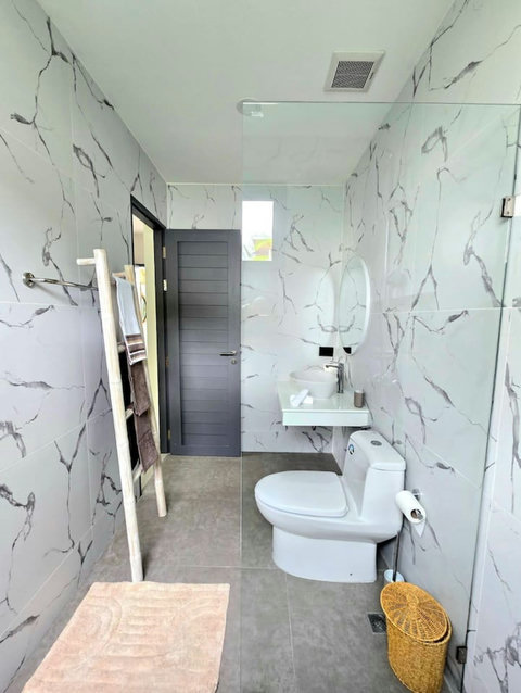 Marble-tiled bathroom with walk-in shower and modern design