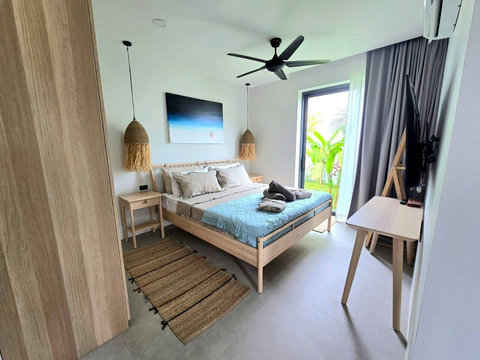 Bright twin bedroom with tropical garden views