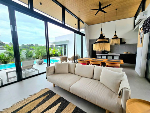 Spacious open-air living room with vaulted wooden ceiling