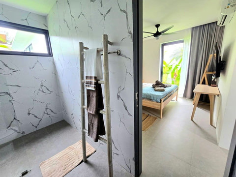 Twin bedroom with garden access through glass doors